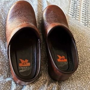 Brown floral tooled clogs